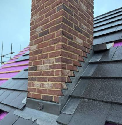 Shingles meeting step flashing at a brick chimney